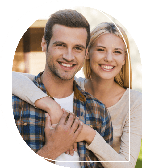 Young man and woman smiling outdoors together after cosmetic dentistry in Wallingford