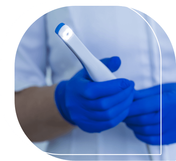 Dental professional holding thin white intraoral camera