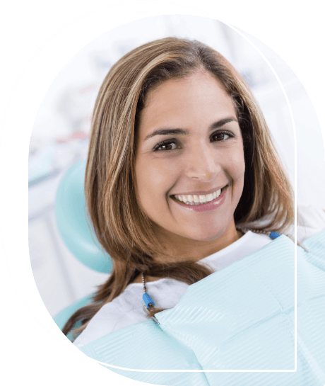 Woman sitting in dental chair and grinning