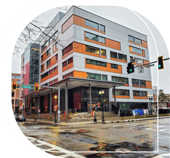 Multistoried orange and gray building on street corner