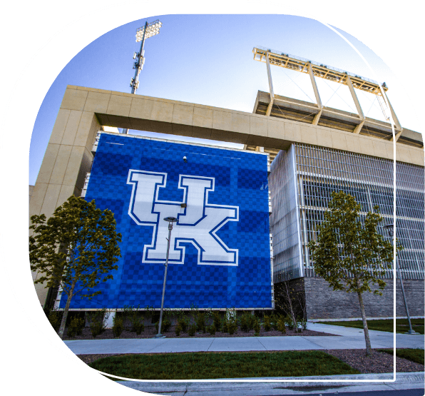 University of Kentucky logo on the outer wall of bleachers at a football stadium