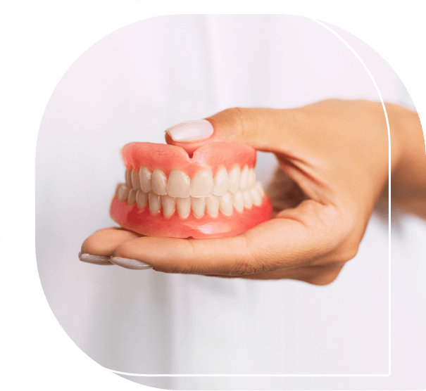 Dentist holding a set of full dentures