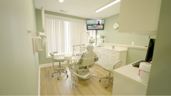 Dental exam room with a window and white walls