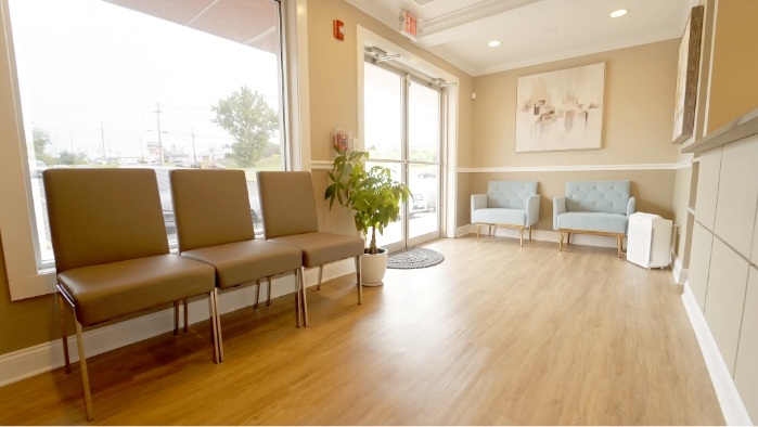 Chairs on clean wooden floor in waiting area