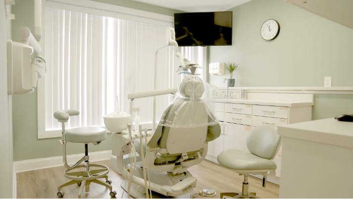 Dental treatment room with a window and white walls