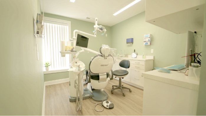 Dental exam room with white walls and a window