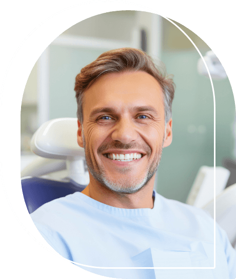 Smiling man sitting in dental chair during preventive dentistry visit