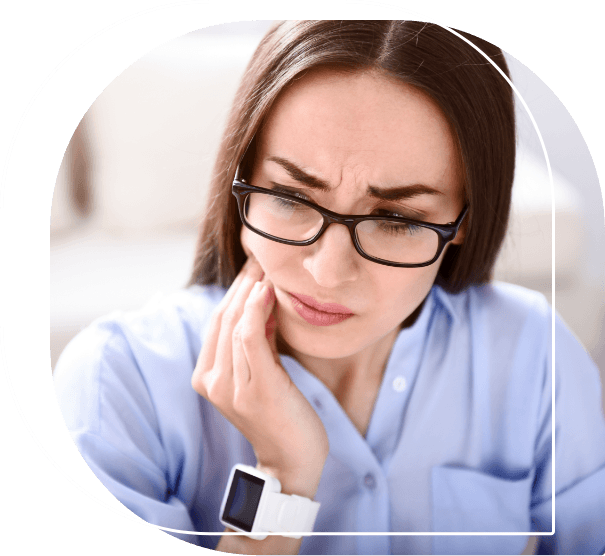 Woman wincing in pain while holding the side of her jaw